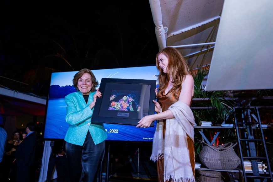 Sylvia A. Earle & Amber Sparks holding up coral reef underwater rigs award