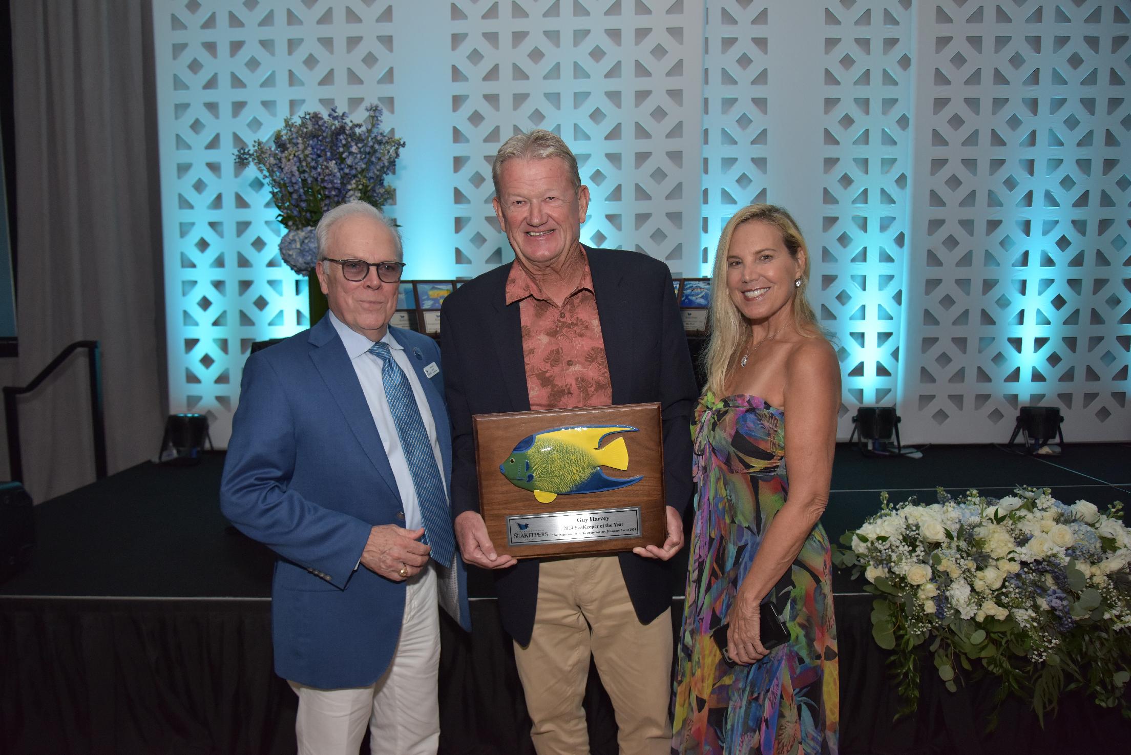 Michael T. Moore (Chairman Emeritus, SeaKeepers), Guy Harvey (2024 SeaKeeper of the Year), & Beth Bernstein (YATCO) at The International SeaKeepers Society's Founders Event 2024
